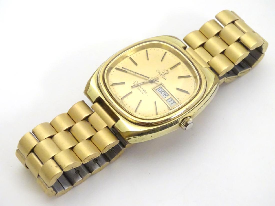 Omega : a gold plate Seamaster Automatic Gentleman's: Omega : a gold plate Seamaster Automatic Gentleman's Wristwatch , with Italian days and Arabic Numbers , shaped square dial , gilt Matt dial , gilded baton hours , movement number 'Omega 37337776 ', s