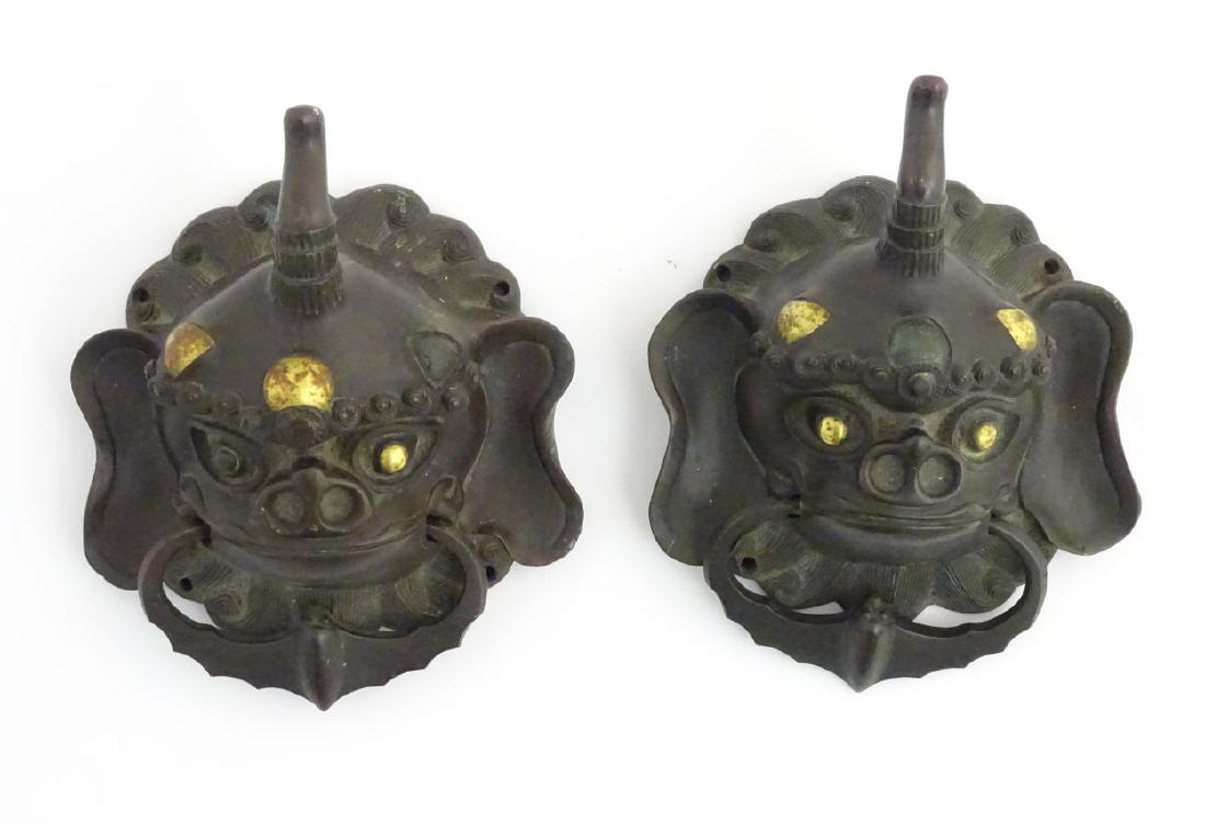 A pair of 18thC / 19thC bronze and gilded door knockers: A pair of 18thC / 19thC bronze and gilded door knockers formed as mythical animals. with bat detail 6 1/2'' x 4 1/2''