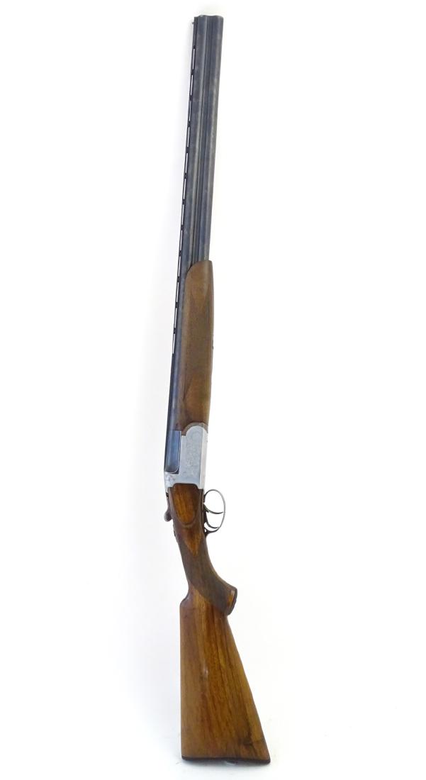 Shotgun: a 12 bore over & under shotgun by E. Contento,: Shotgun: a 12 bore over & under shotgun by E. Contento, 27 1/2'' barrels with 2 3/4'' chambers and ventilated top rib. Silvered action with double triggers, cross bolt and foliate scroll engraving. Wa
