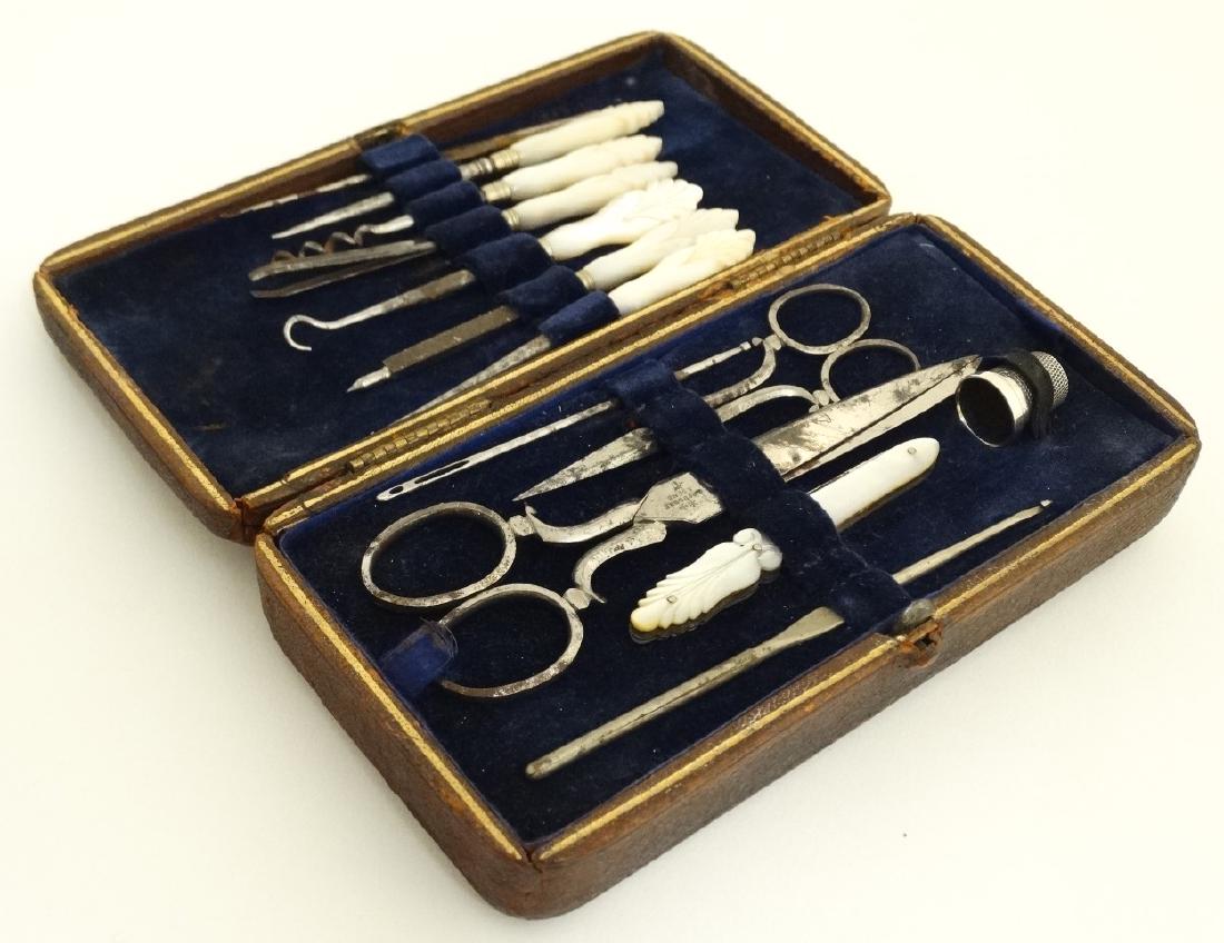 Sewing / Needlework interest : A 19thC sewing etui of: Sewing / Needlework interest : A 19thC sewing etui of gold tooled leather opening to reveal mother of pearl handed accoutrements, silver thimble etc and with lift out tray revealing thread under, the 