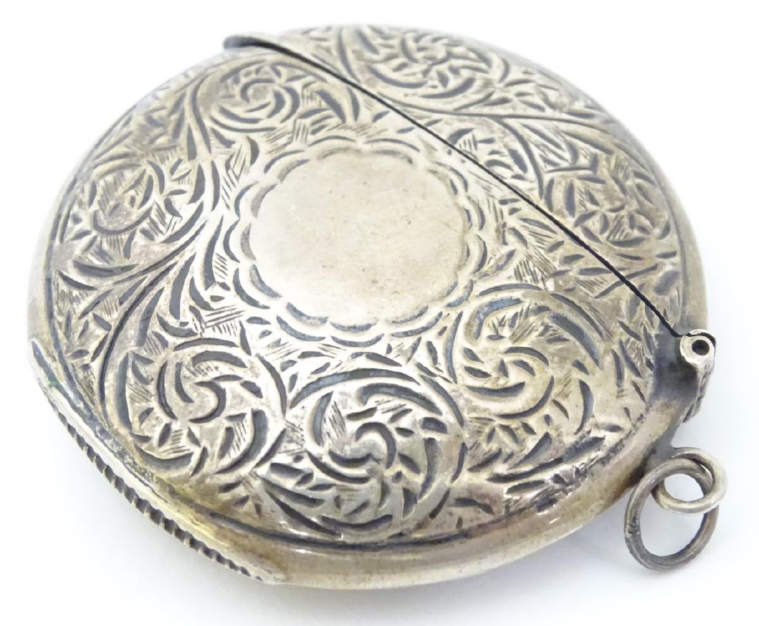 A silver vesta case of circular form with hinged lid.: A silver vesta case of circular form with hinged lid. Hallmarked Sheffield maker David Scott-Walker Approx 2'' wide