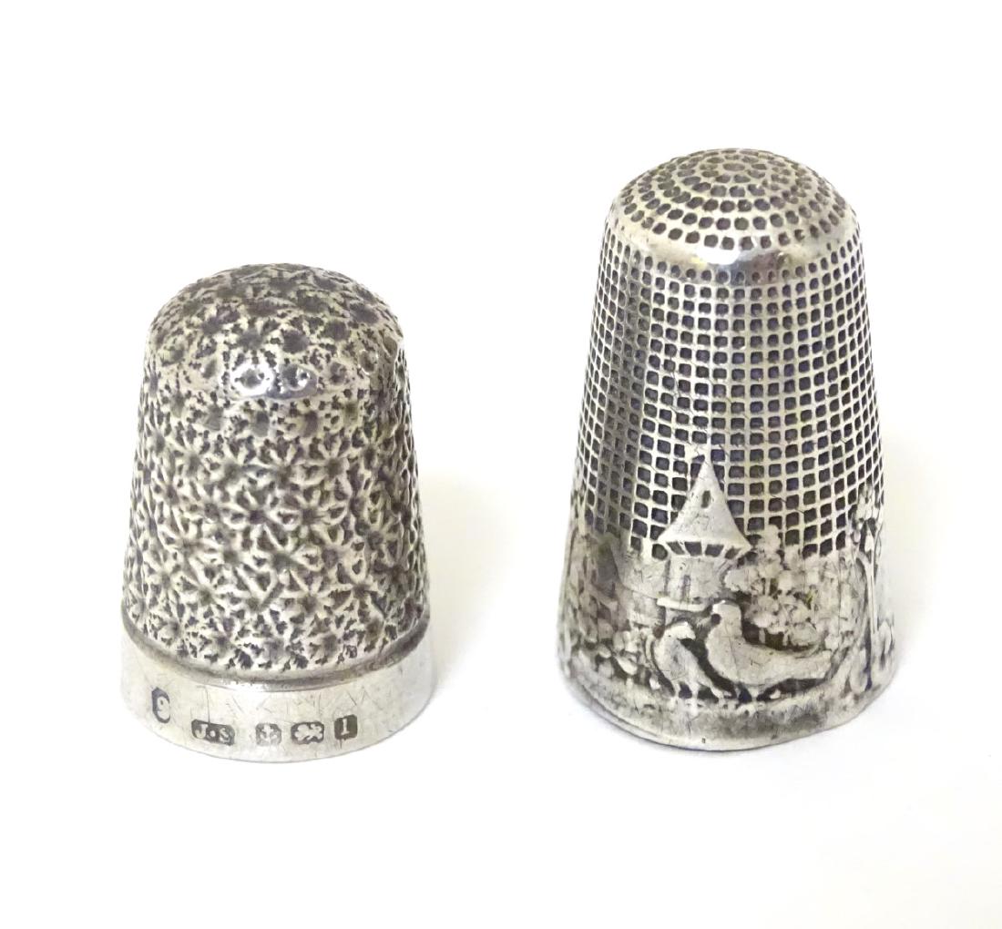 A silver thimble hallmarked Birmingham 1910 maker James: A silver thimble hallmarked Birmingham 1910 maker James Swann, together with a Continental silver example decorated with doves / love birds etc (2)