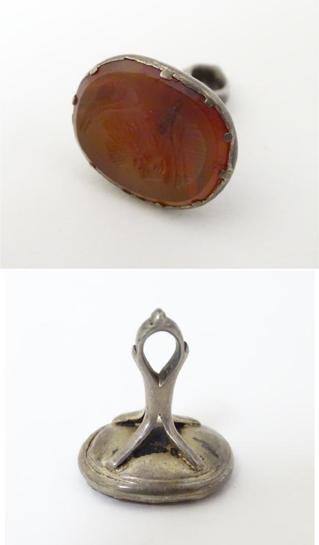 A 19thC fob seal set with carved carnelian seal under: A 19thC fob seal set with carved carnelian seal under depicting the head of a classical man 7/8'' high