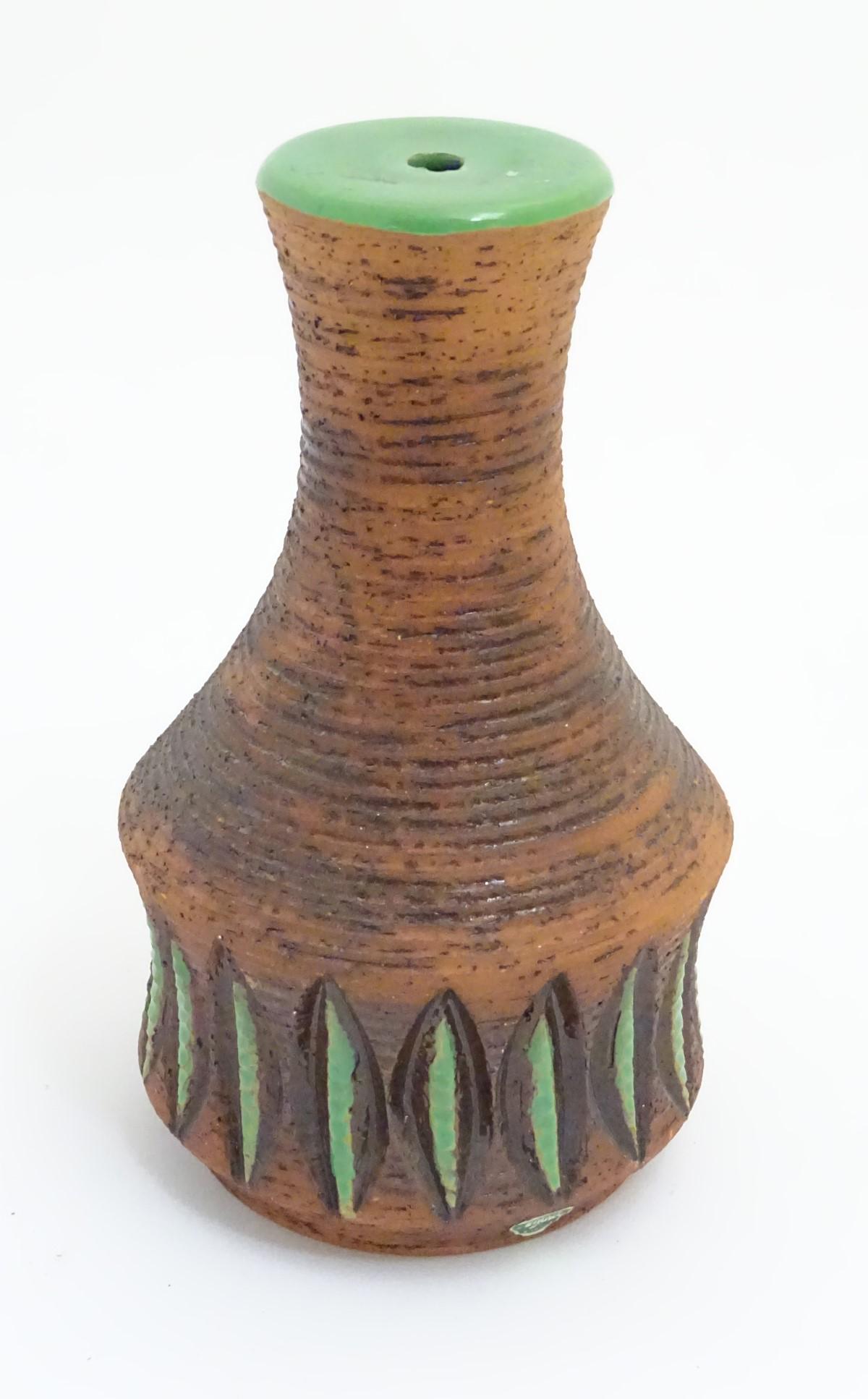Scandinavian Pottery: A mid / late 20thC Ninnie Ekberg: Scandinavian Pottery: A mid / late 20thC Ninnie Ekberg Forsgren, Sweden , Studio Pottery lamp stand having brown ridged design with green details, bears mark to base. 9'' high.