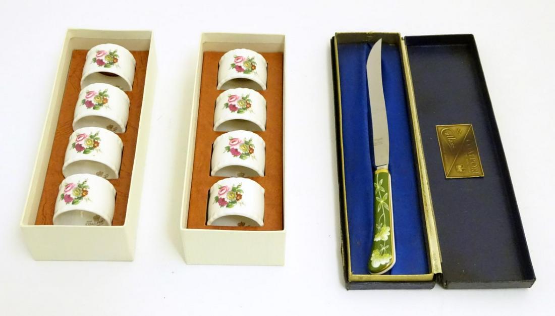 Two sets of four cased Coalport ceramic napkin rings,: Two sets of four cased Coalport ceramic napkin rings, in the pattern Ludlow, together with a Cutlass & Coalport cased cake knife with a fine bone china green handle with foliate decoration.