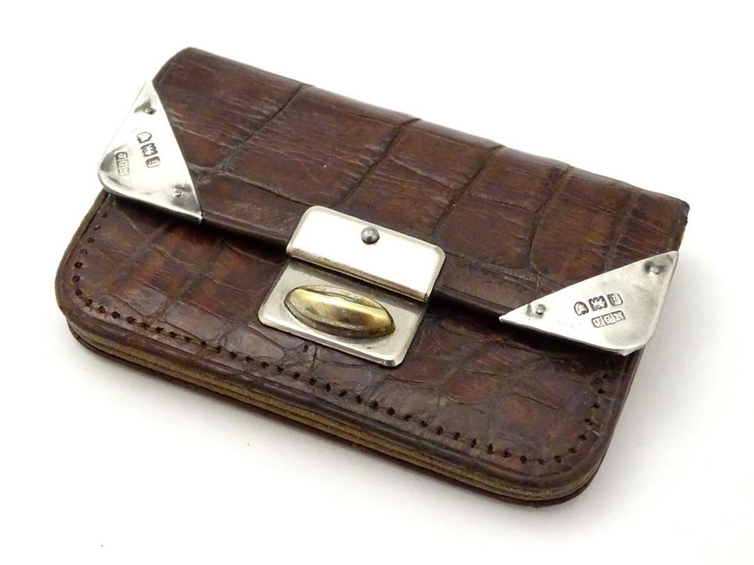 A silver mounted brown leather purse with silver: A silver mounted brown leather purse with silver corners hallmarked London 1904 maker James George Newbold 3'' wide