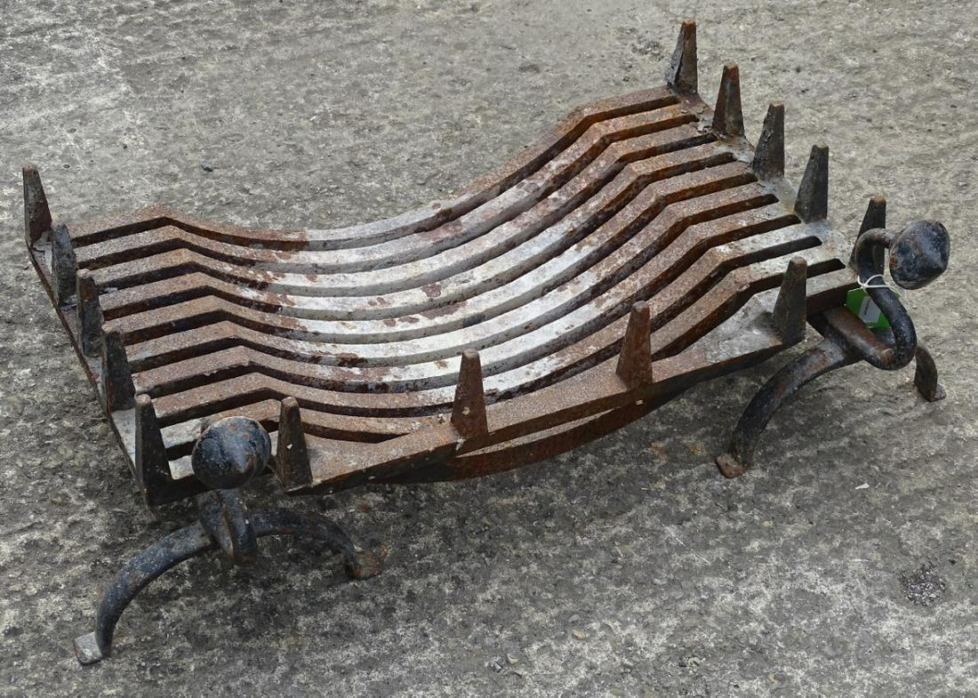 Fire grate: a cast iron breakfront fire basket together: Fire grate: a cast iron breakfront fire basket together with an associated wrought iron pair of andirons. The fire dogs having circular cone shaped decoration to ends on swan neck supports. Basket 25'
