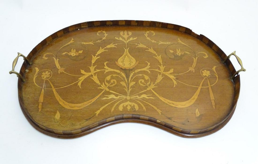 An Edwardian inlaid mahogany and Sheraton revival: An Edwardian inlaid mahogany and Sheraton revival kidney shaped butlers tray with checkered border 25 1/2'' wide