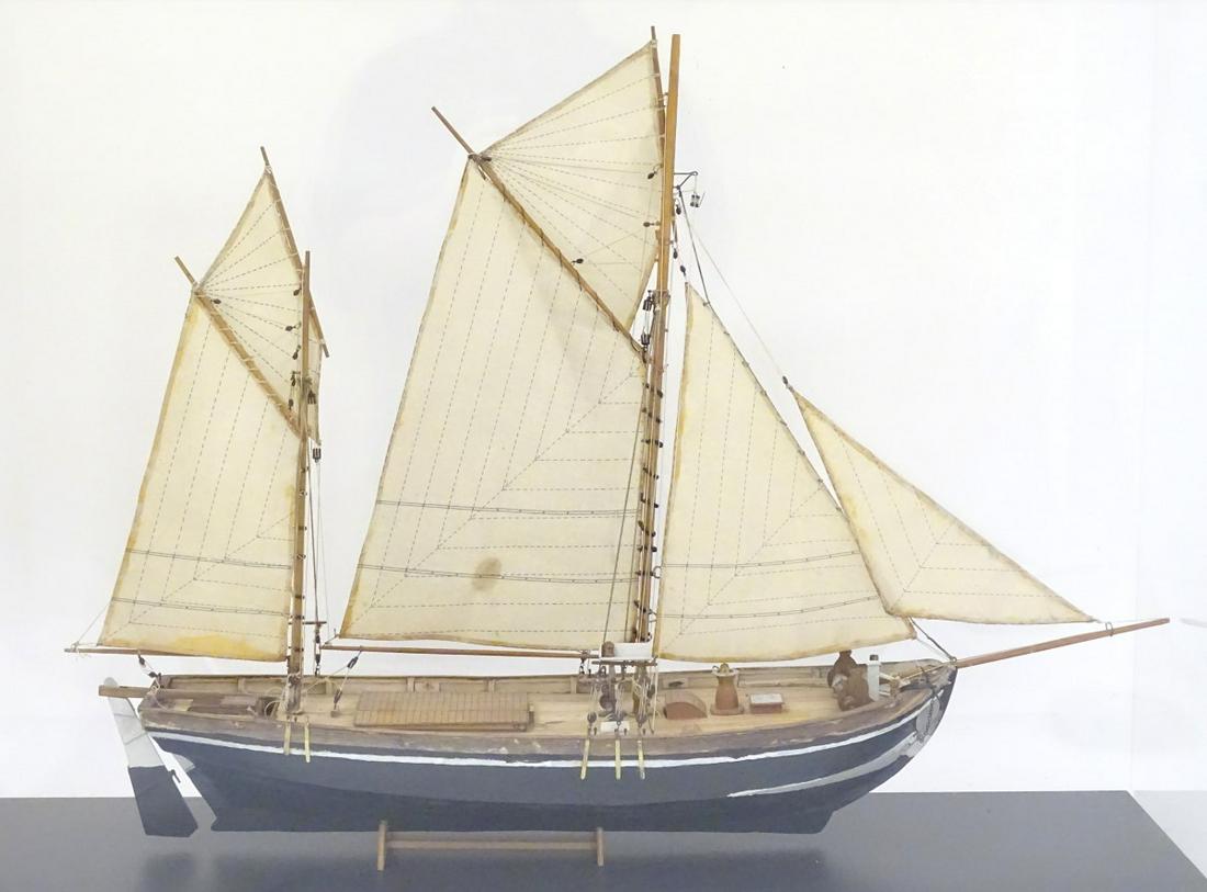 Ship in a case: a scale model of a circa 1900 two: Ship in a case: a scale model of a circa 1900 two masted fishing smack in a perspex case. 36'' wide x 25 1/2'' high x 10'' deep.