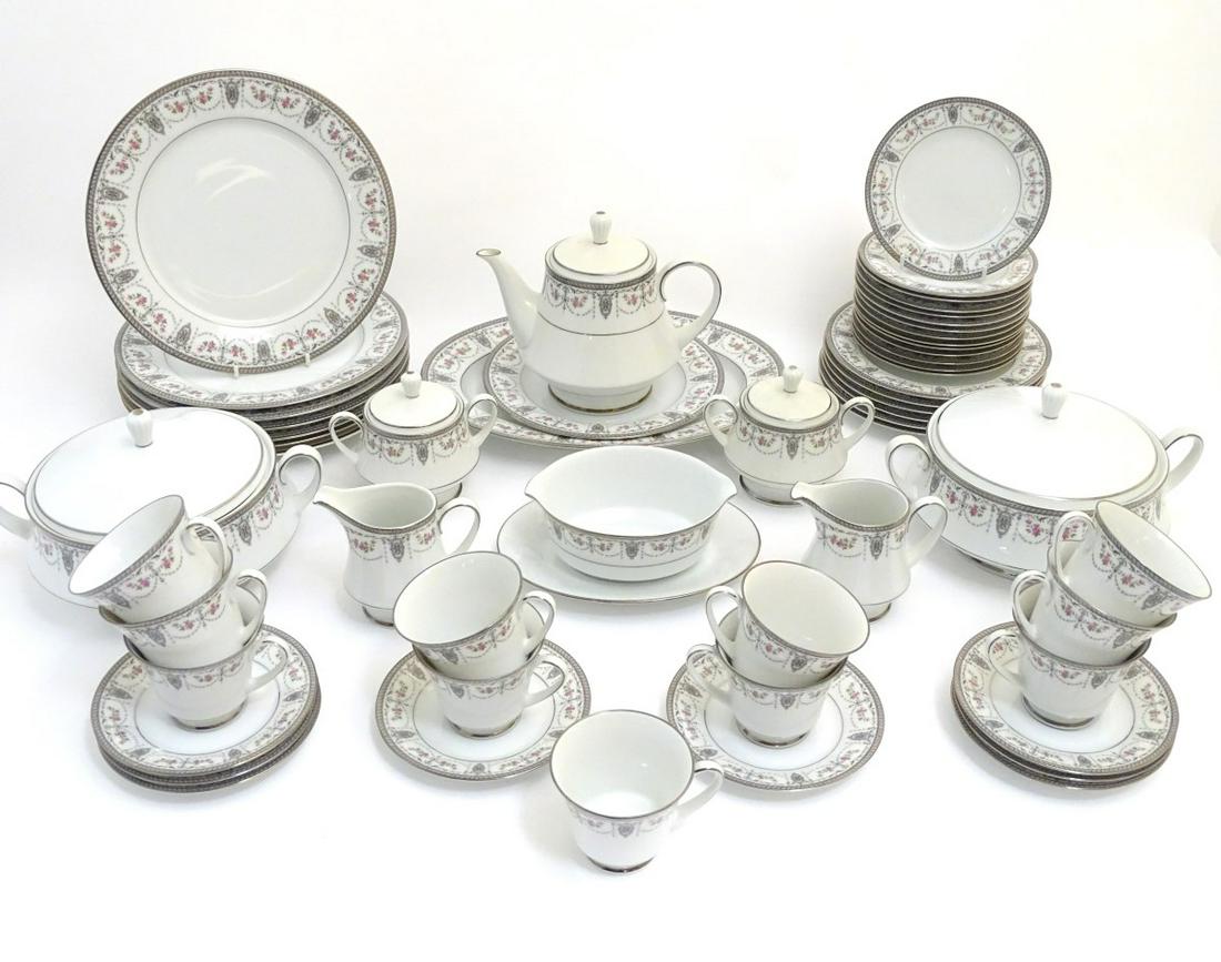 A quantity of Noritake 'Clarice' dinner/tea wares, made: A quantity of Noritake 'Clarice' dinner/tea wares, made in Japan, with pink rose and silver lustre garland decoration. To include 2 twin handled, circular lidded tureens (7 1/2'' diameter), 7 dinner p