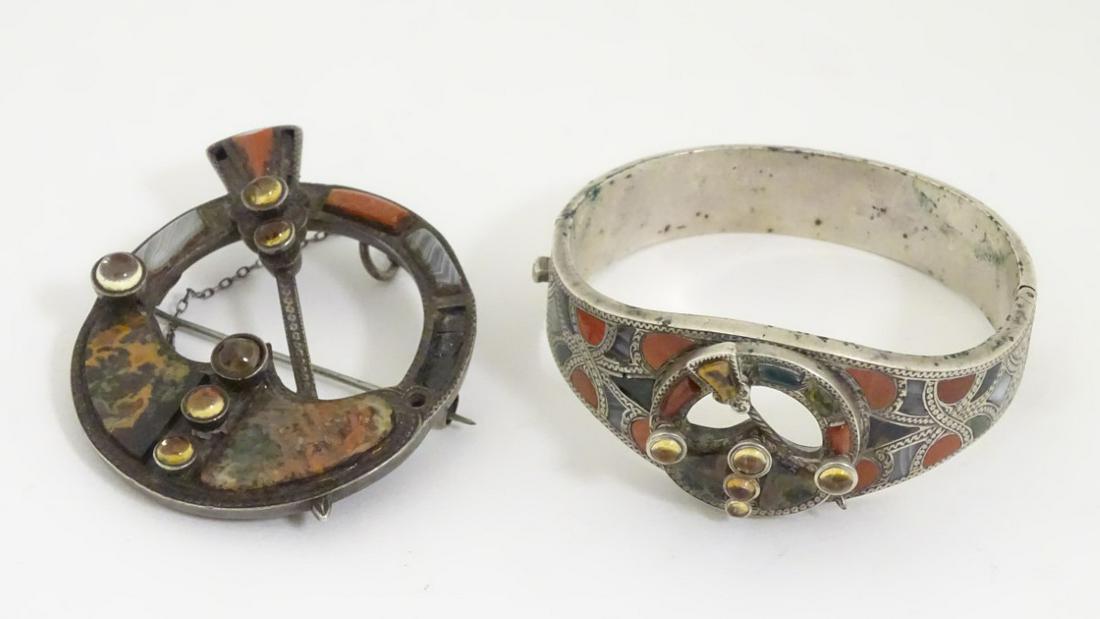 Scottish jewellery : A white metal bangle set with: Scottish jewellery : A white metal bangle set with various hardstone agate and carnelian decoration with central penannular decoration. Together with a brooch with similar decoration and marked with V