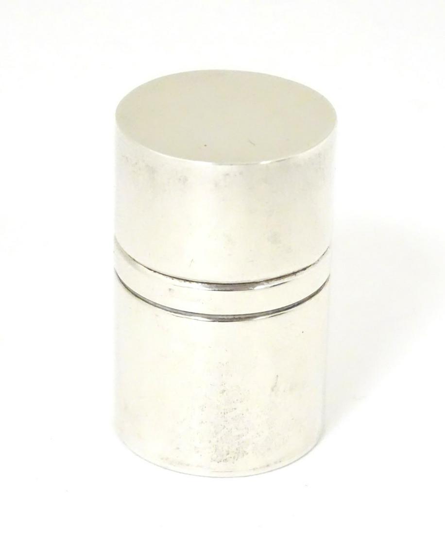A silver pill box of cylindrical form. Hallmarked: A silver pill box of cylindrical form. Hallmarked London 1977. 1 1/2'' high (38g)