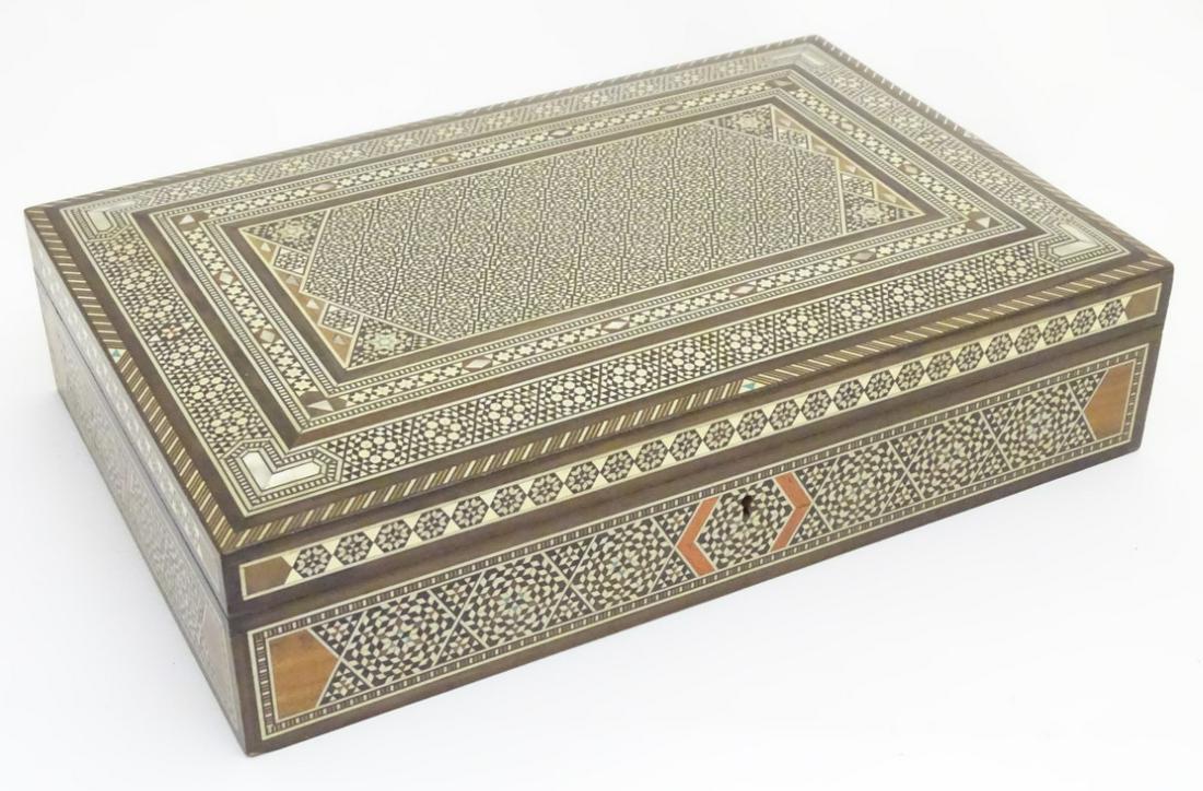An Indian lidded sandalwood box with inlaid mother of: An Indian lidded sandalwood box with inlaid mother of pearl, bone and micromosaic, with ebony strip inlay. 13 3/8'' wide.