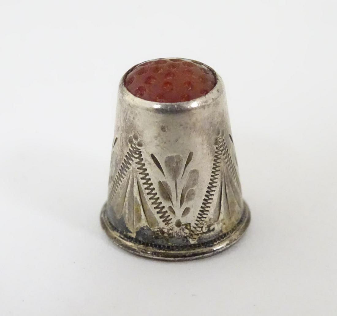 A small silver thimble set with carnelian hardstone: A small silver thimble set with carnelian hardstone tip. ½'' long