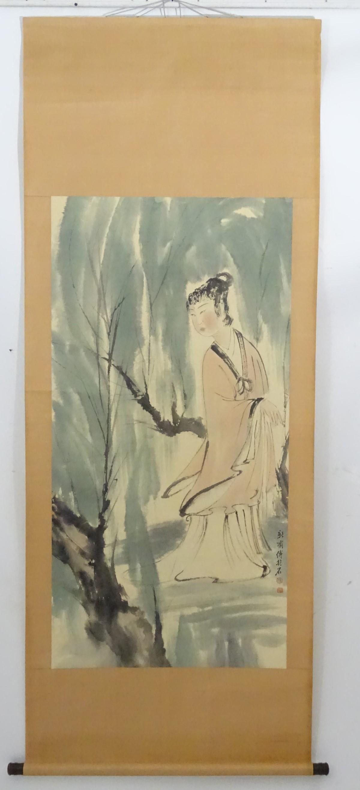 Chinese Scroll : a hand painted image of a woman in a: Chinese Scroll : a hand painted image of a woman in a garden , signed lower right, measuring 55 x 26 1/2'' wide , mounted on a silk paper backing.