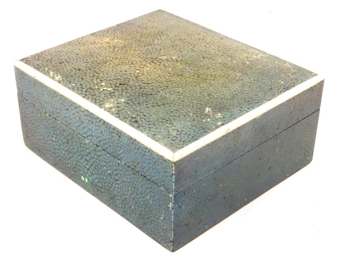 An early 20thC green shagreen box of rectangular form: An early 20thC green shagreen box of rectangular form with wood lined interior and banding around the top. Approx. 2 1/8'' high x 4 1/2'' wide x 4'' deep.