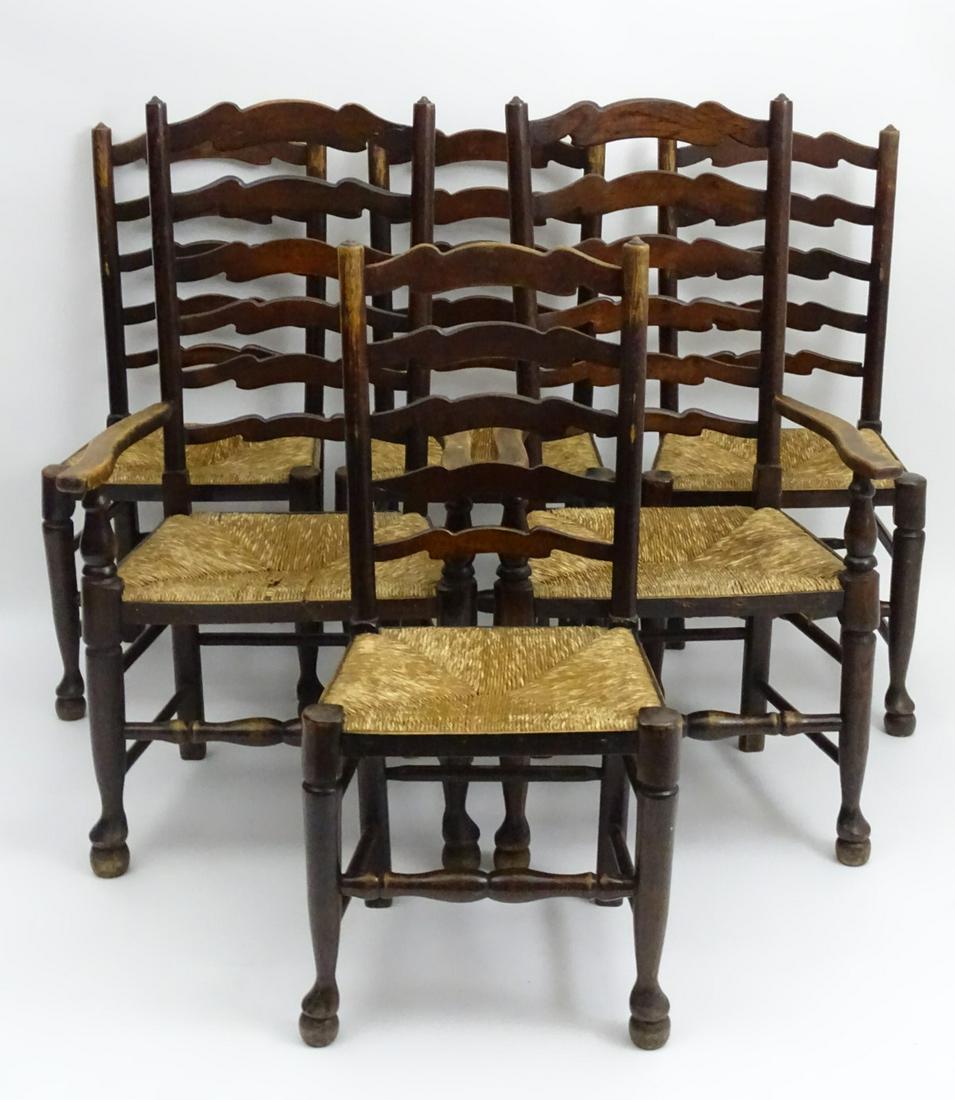 A set of six 19thC oak dining chairs with ladder backs: A set of six 19thC oak dining chairs with ladder backs and envelope rush seats, the chairs raised on turned front legs and block back legs all united by a box stretcher. 24'' wide x 21'' deep x 43'' h
