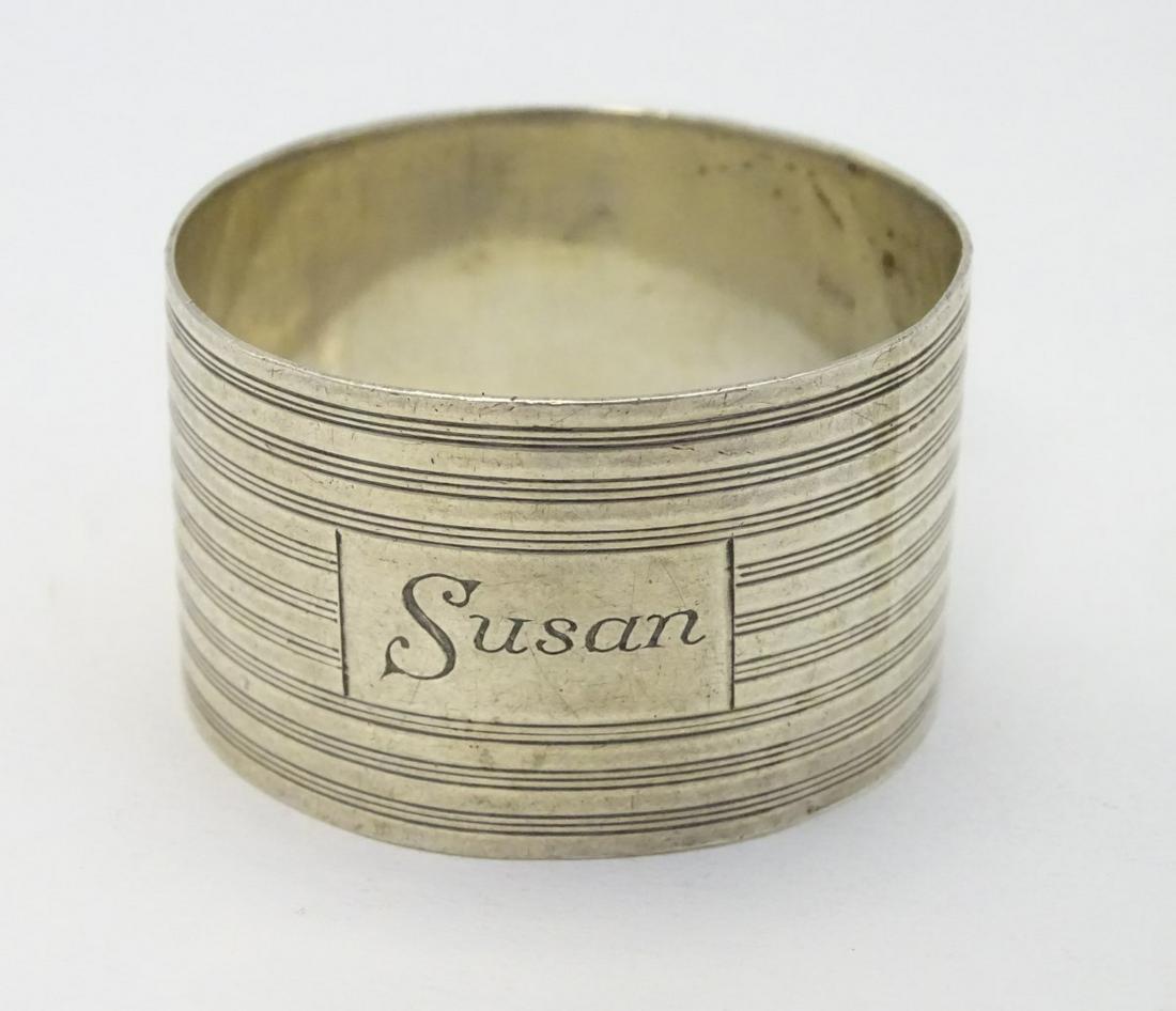 An Art Deco silver napkin ring with banded decoration.: An Art Deco silver napkin ring with banded decoration. Hallmarked London 1945 maker GFB