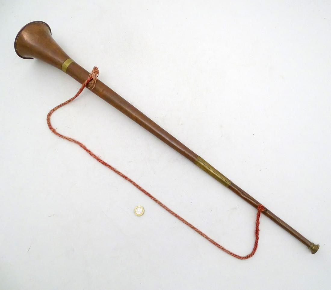 A copper and brass coaching horn, 32 1/2'' long: A copper and brass coaching horn, 32 1/2'' long