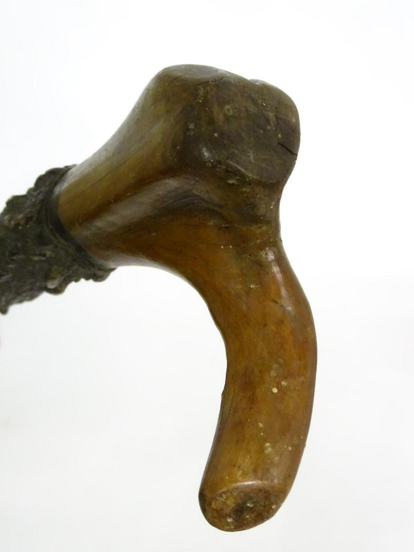 A highly knurled 19thC blackthorn walking stick with: A highly knurled 19thC blackthorn walking stick with carved handle, 35 1/4'' long