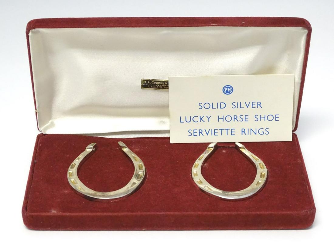 A pair of novelty silver napkin rings formed as 'Lucky: A pair of novelty silver napkin rings formed as 'Lucky Horse Shoes' hallmarked Sheffield 1981 maker Francis Howard Ltd. 2 1/4'' long