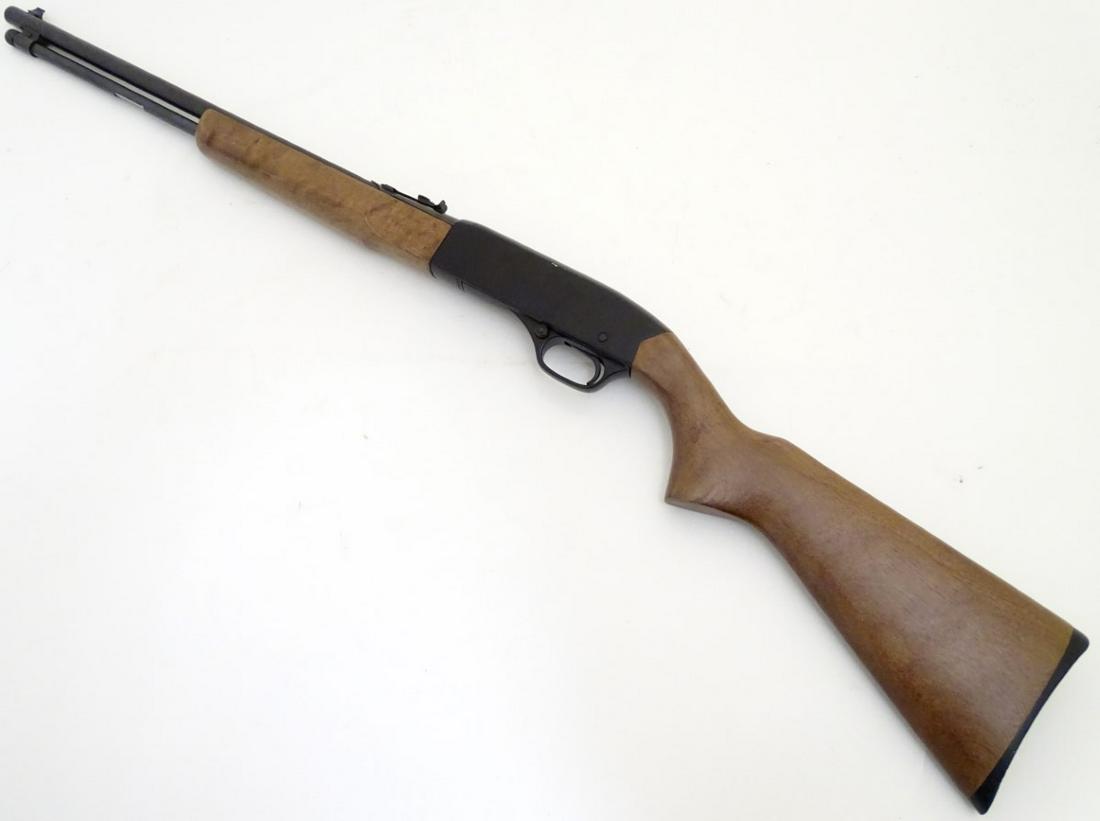 Firearm: a Winchester 'Model 190' .22LR semi-automatic: Firearm: a Winchester 'Model 190' .22LR semi-automatic rimfire rifle, 20 3/4'' barrel with open sights fitted and tube magazine under. Beech pistolgrip stock and fore-end. Serial number B1414440 Pleas