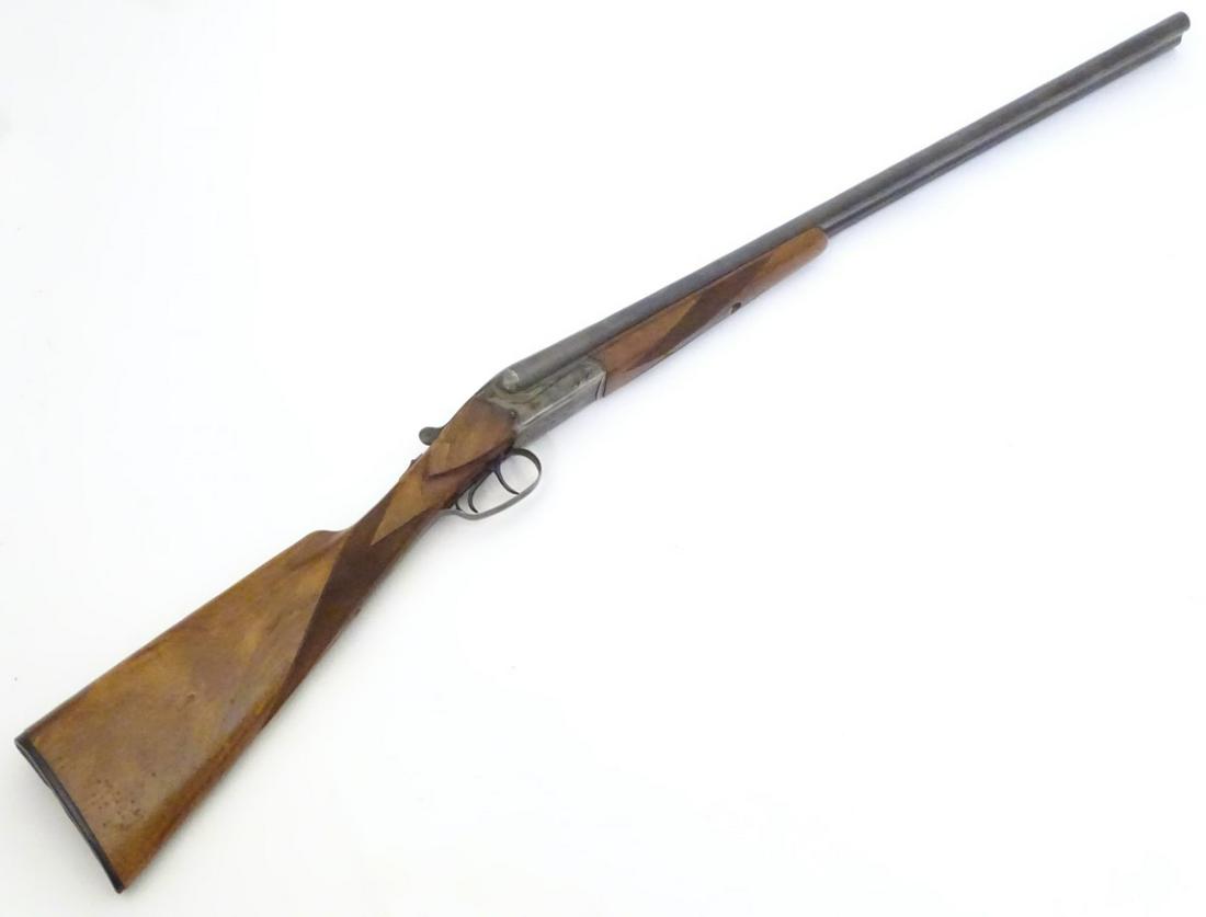 Shotgun: a Merkel 16 bore side by side boxlock: Shotgun: a Merkel 16 bore side by side boxlock non-ejector, walnut straight-hand stock with chequered palm and fore-end, 14 1/2'' LOP. 28'' barrels with raised, tapering, concave file-cut rib and 2 3/