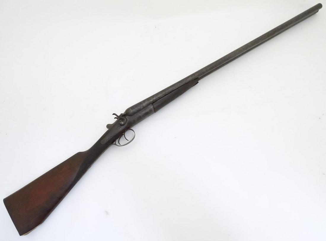 Shotgun: a 12 bore back-action toplever side by side: Shotgun: a 12 bore back-action toplever side by side hammergun by Thomas Wild, Birmingham. 30'' steel barrels with concave rib (engraved with the maker's name and address) bead foresight and 2 1/2'' c