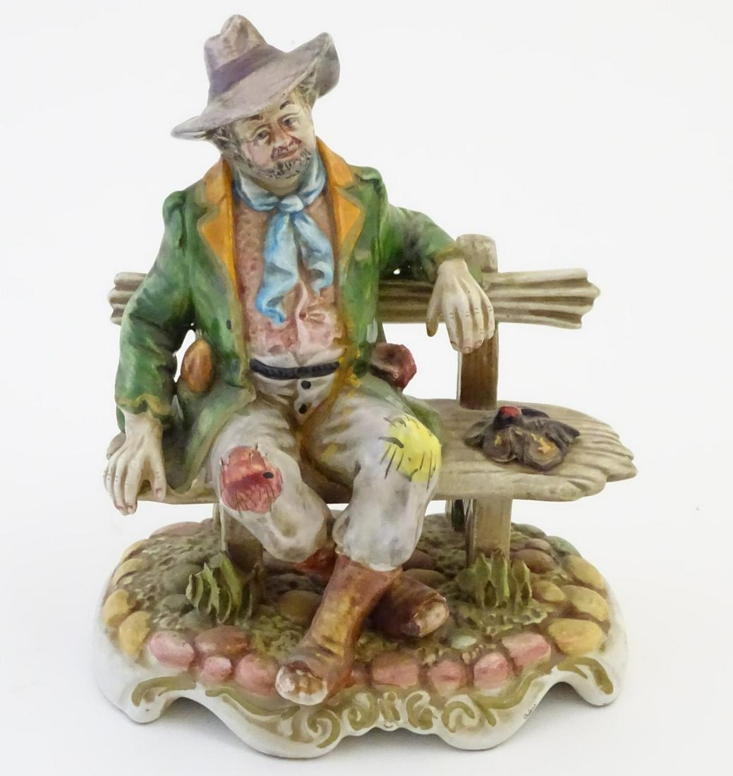 A Capodimonte figure modelled as a tramp wearing a hat: A Capodimonte figure modelled as a tramp wearing a hat on a bench. Impressed 1529 under the bench, 1525, 6-7-8-9, Made in Italy and crowned Naples mark under. Approx. 7 1/2'' high.