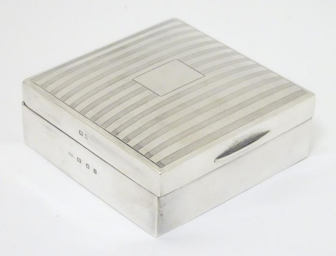 A silver table top cigarette box with banded engine: A silver table top cigarette box with banded engine turned decoration hallmarked London 1932 maker Thomas William Lack 3 1/4'' x 1 1/4'' x 3 1/4''