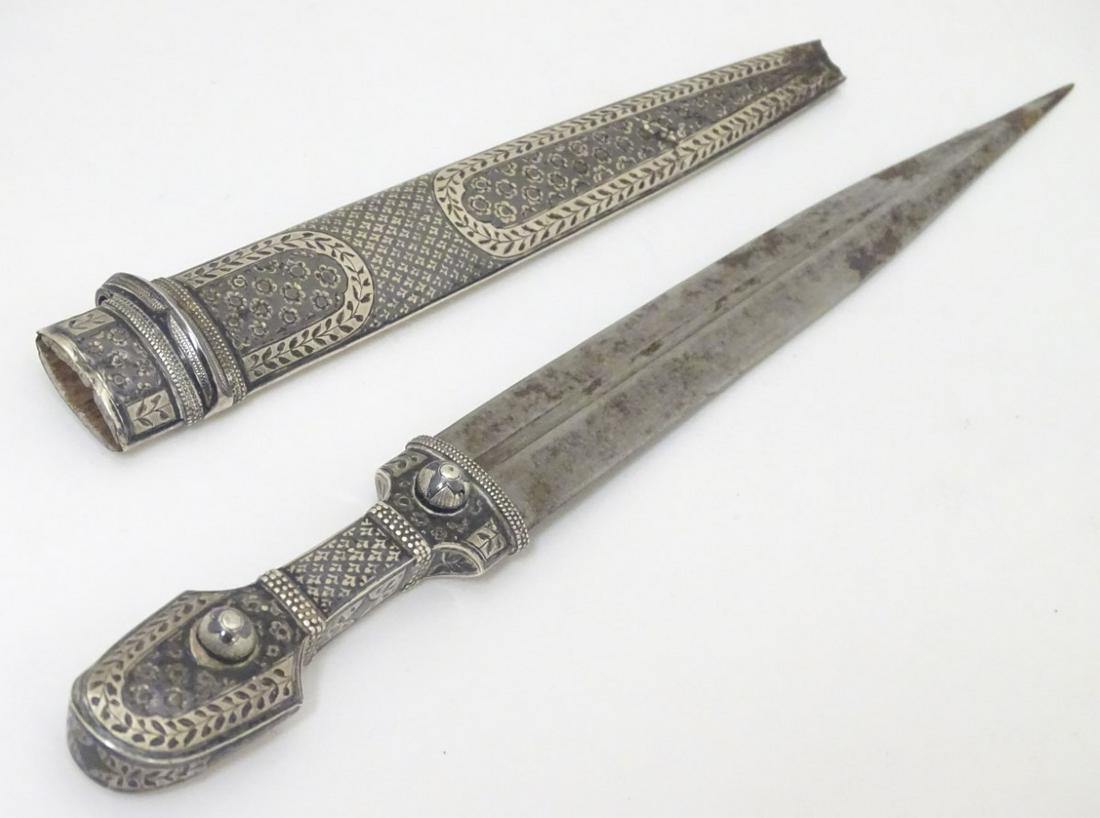 A Russian knife and scabbard, the knife handle and: A Russian knife and scabbard, the knife handle and scabbard with niello decoration and scabbard marked with Russian silver marks. The whole 9 1/2'' long