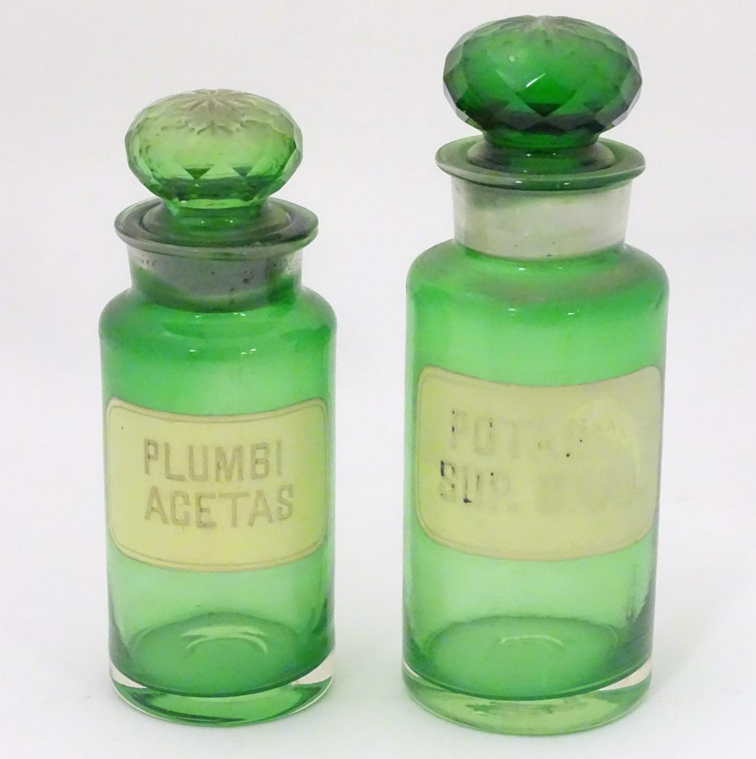 Two 20thC green glass pharmacy / chemist / apothecary: Two 20thC green glass pharmacy / chemist / apothecary bottles, one labelled Plumbi Acetas, the other Potassi. Sup. Oxal. Tallest approx. 7 1/2''