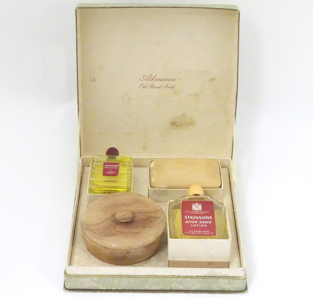 A mid-20thC Men's shaving set by Atkinsons, Old Bond: A mid-20thC Men's shaving set by Atkinsons, Old Bond Street. The box containing soap and shaving soap (within a treen pot and cover), bottles of lotion and 'Brilliantine' aftershave.
