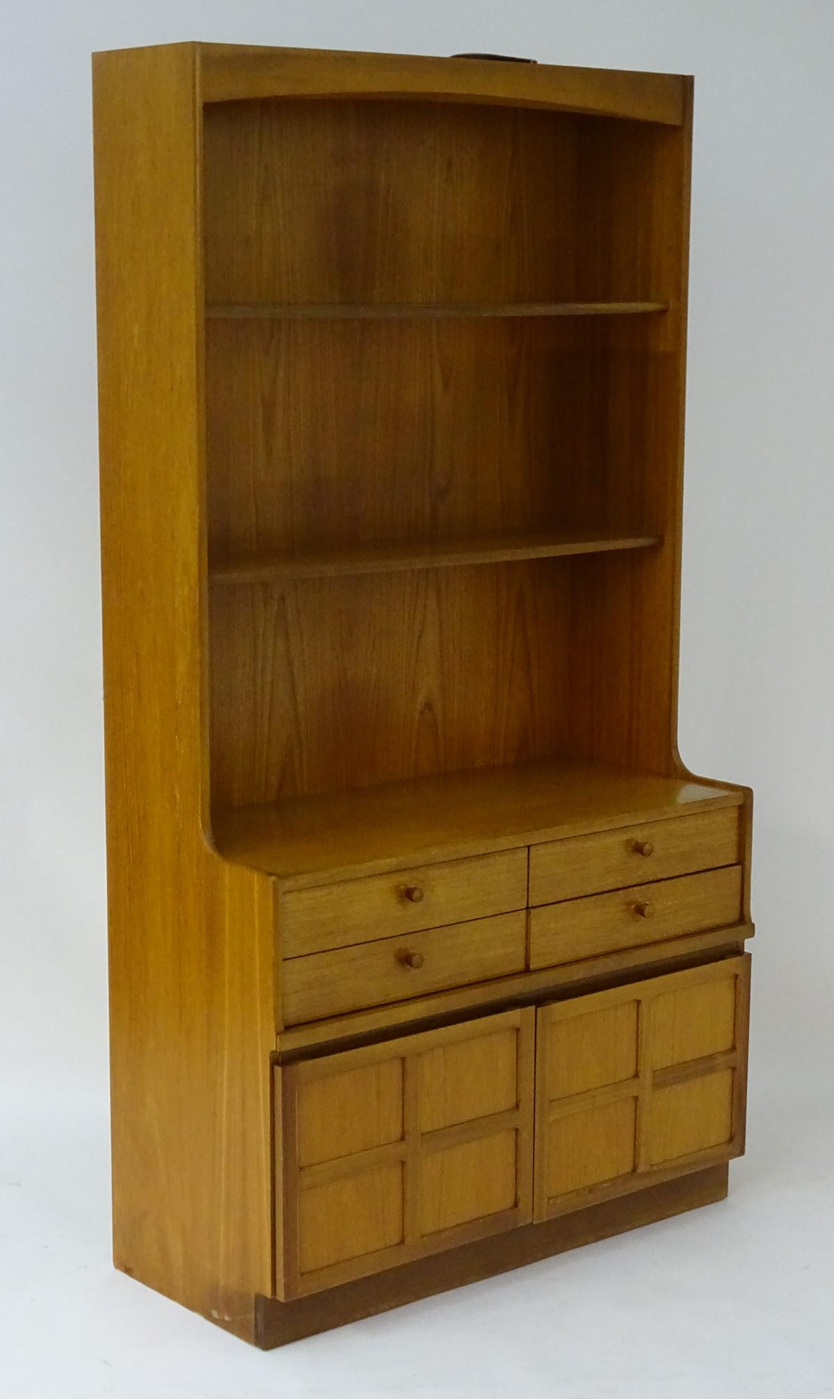 A mid / late 20thC teak wallboard dresser unit by: A mid / late 20thC teak wallboard dresser unit by Nathan Furniture, together with a matching cupboard. The dresser 17 1/2'' deep, 76'' tall, 40'' wide, the cupboard 17 1/2'' deep, 29 1/2'' tall, 20'' 
