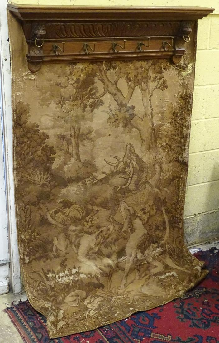 An early / mid 20thC oak cloak rack with five brass: An early / mid 20thC oak cloak rack with five brass hangers flanked by satyr lion masks, 47 ½'' long
