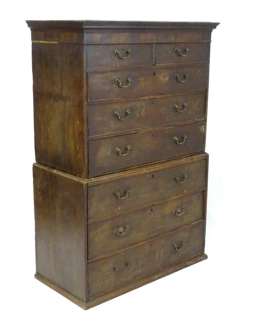 A late Georgian mahogany chest on chest, having a: A late Georgian mahogany chest on chest, having a moulded cornice above two short drawers and six long graduated drawers with swan neck handles.
