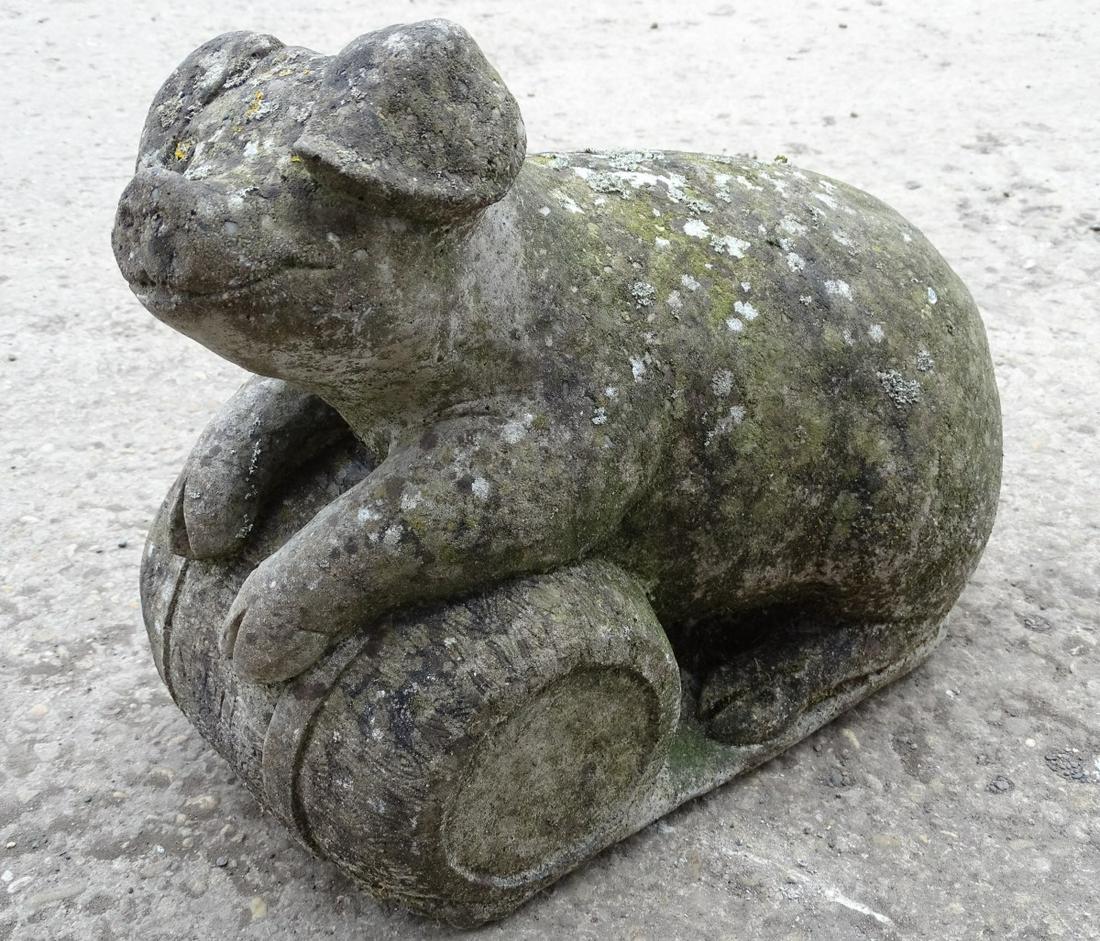 A 20thC reconstituted stone model of a pig resting on a: A 20thC reconstituted stone model of a pig resting on a barrel, approximately 15'' long
