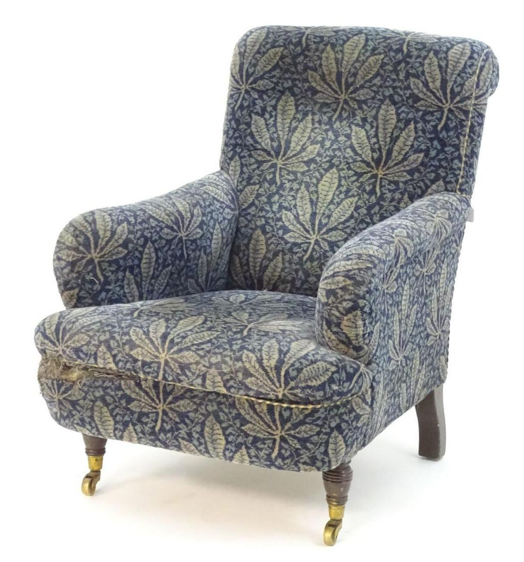 An early 20thC station master's office armchair with sw: An early 20thC station master's office armchair with swept arms and standing on turned front legs terminating in brass caps and castors and block back legs. The castors marked LNWR (London Northwest R