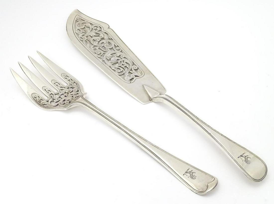 A Victorian pair of Old English Thread pattern fish: A Victorian pair of Old English Thread pattern fish servers with engraved armorial to handles. Hallmarked London 1868, maker Chawner & Co. (George William Adams). Largest approx. 13" long (2)