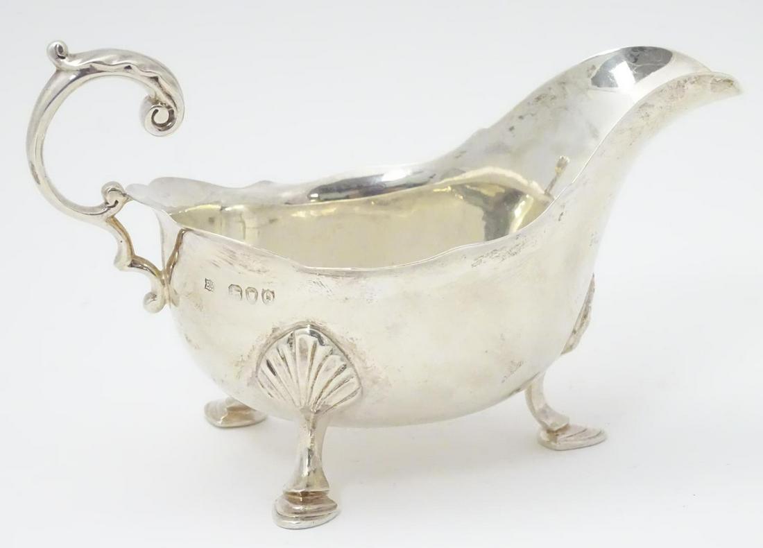 A Victorian silver sauce boat hallmarked London 1891: A Victorian silver sauce boat hallmarked London 1891 maker William Hutton & Sons (Edward Hutton). 6" long (180g)