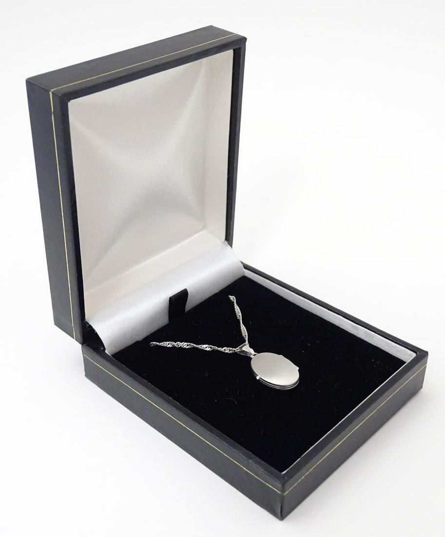 A Hallmarked silver locket on chain. Locket approx 1/4": A Hallmarked silver locket on chain. Locket approx 1/4" long, chain approx 18" long.