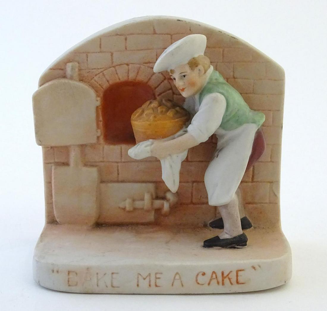 An English flatback fairing depicting a baker and his: An English flatback fairing depicting a baker and his oven in relief, with caption 'Bake me a Cake'. Approx. 3 1/2" high