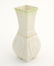 A small Belleek bud vase of squared form with fluted