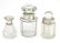 Three glass scent bottles with silver lids/collars.