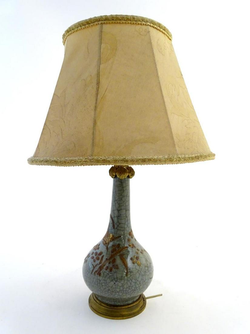 Lighting: an early-to-mid 20thC Oriental table lamp,: Lighting: an early-to-mid 20thC Oriental table lamp, with brass fitments and base, the ceramic body with craquelure finish, overpainted with floral and ornithological decoration. 19 1/4" tall