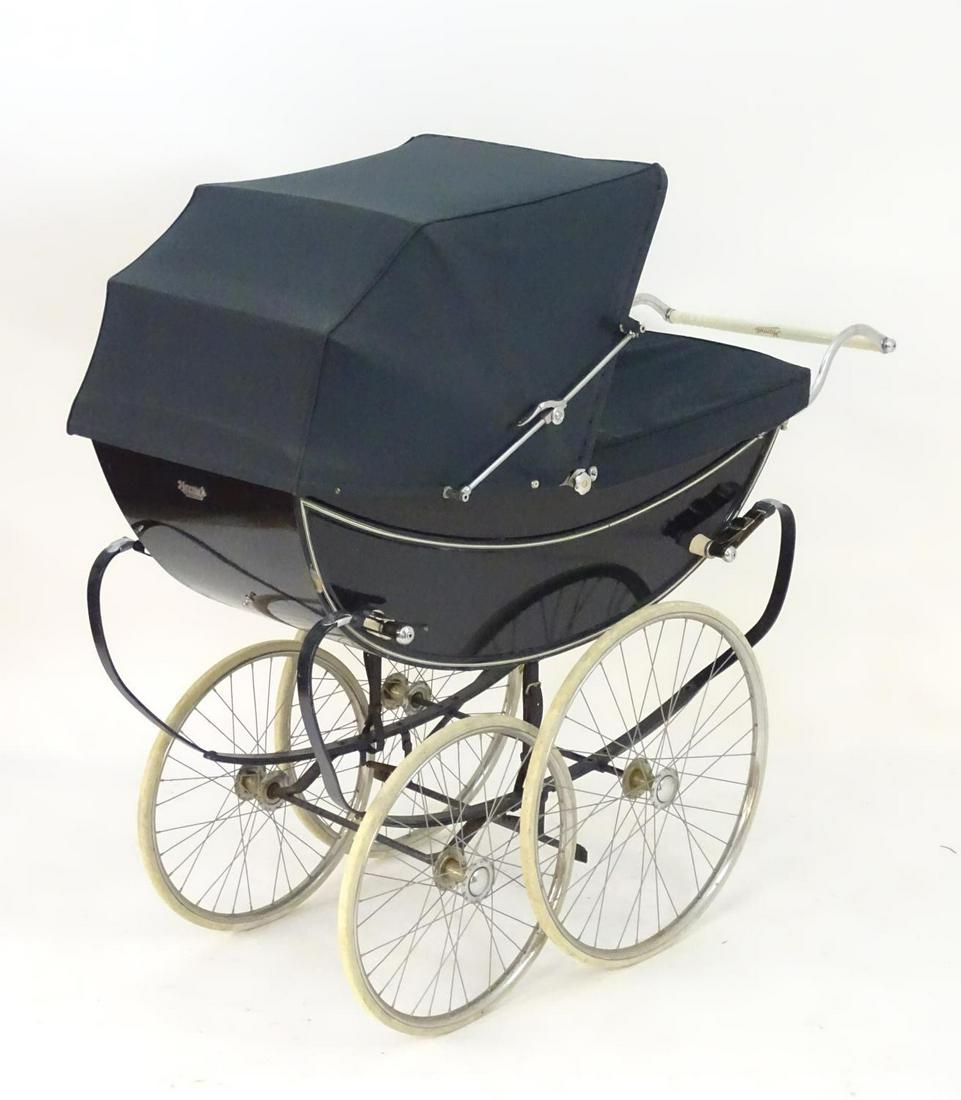 A mid-20thC Marmet coach-built perambulator/pram in: A mid-20thC Marmet coach-built perambulator/pram in navy blue, 53" long, 24" wide, 52" tall