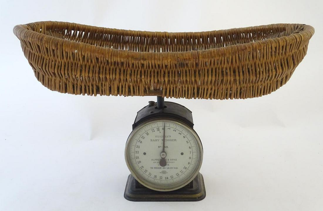 An early 20thC Hughes's Baby Weigher / weighing scales: An early 20thC Hughes's Baby Weigher / weighing scales with a wicker basket by Salter. Model no. 48. Approx. 14" high overall.