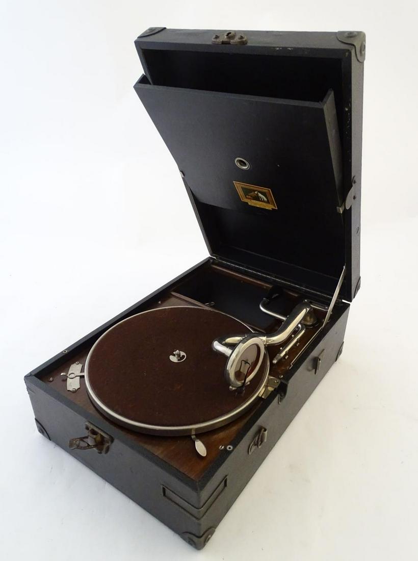 An early-20thC portable gramophone by The Gramaphone: An early-20thC portable gramophone by The Gramaphone Company Ltd for His Master's Voice, cased, chrome playing arm and winding handle, with compartment containing playing needles and key. 16? x 11? x 