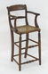 A 19thC walnut child's chair with a carved cresting