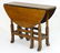 A late 19thC oak gateleg table, having drop flaps